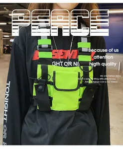 Neon green tactical chest bag detail with reflective straps for street style