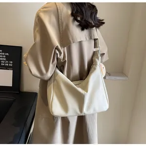 Large cream hobo shoulder bag for women shown on model for style and scale context