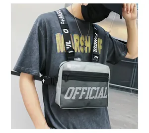 Detailed look at a grey hip hop tactical chest rig bag worn by a street style model