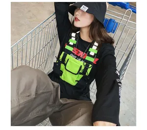 Neon green tactical chest bag with reflective straps in a street style setting
