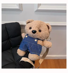 Close-up showing the soft texture of a cute plush teddy bear crossbody bag with overalls