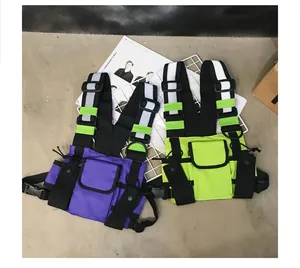 Close-up of tactical functional chest rigs in purple and neon green with reflective webbing straps.
