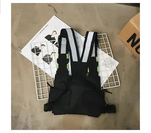Black tactical utility chest bag with high-visibility reflective straps and multiple pockets