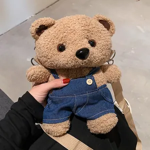 Cute plush teddy bear crossbody bag for women featuring blue denim overalls and strap