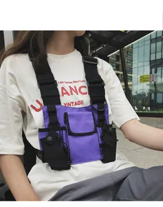 Close-up detail of a purple and black tactical techwear chest bag with adjustable straps
