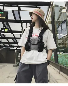 Grey tactical techwear chest bag detail featuring adjustable straps on street model