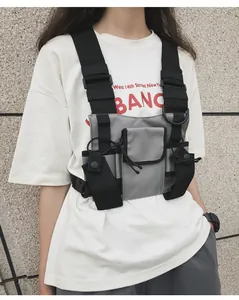 Detailed view of grey functional tactical chest rig bag worn by a model in streetwear style