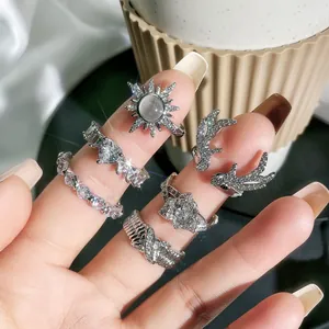 Silver rhinestone ring set featuring deer antler and heart designs on hand.