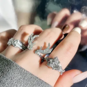 Detailed view of elegant silver antler and floral open ring set with sparkling stones
