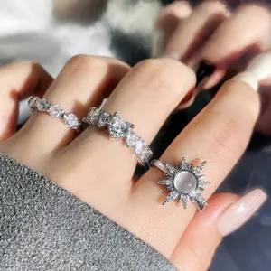Close-up of heart and starburst zircon ring set on hand for women's fashion