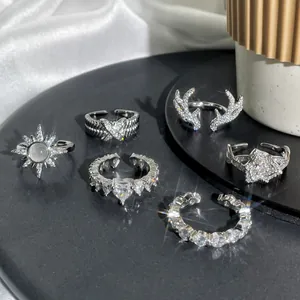 Detailed view of six diverse silver open rings featuring antler, star, and heart designs