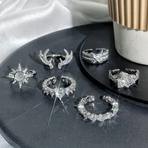 Detail view of assorted silver heart and antler rings with sparkling crystal embellishments.