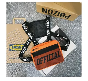 Detailed macro view of orange tactical chest bag with bold OFFICIAL print and straps