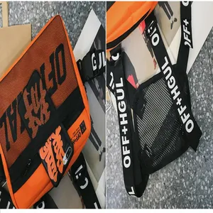 Detail view of orange hip-hop tactical chest bag with mesh pocket and printed straps