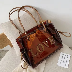 Bolso tote transparente de PVC ámbar con estampado 'LOVE' y bolsa interior naranja
