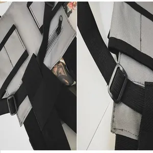 Close-up detail of grey tactical chest bag with adjustable black straps and buckles