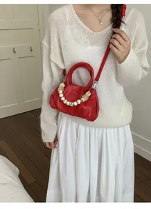 Red pleated cloud handbag with decorative bead handle and shoulder strap