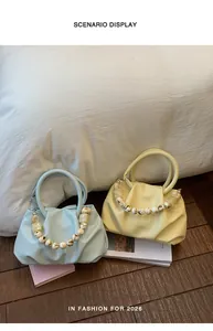 Detailed view of light blue and pale yellow pleated cloud handbags featuring marbled bead handles