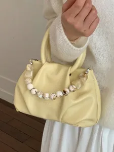 Fashionable pale yellow pleated cloud handbag with decorative marble bead strap