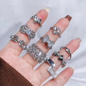 Luxurious sparkling silver open rings set with crystal zircons displayed on fingers