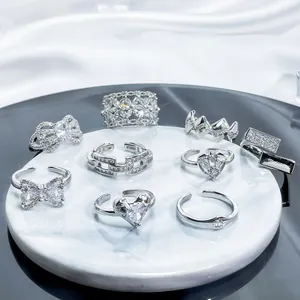 Macro view of adjustable silver rings set with sparkling heart and bow cubic zirconia