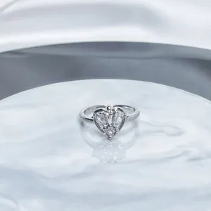 Detailed macro view of a silver adjustable ring featuring a heart-shaped crystal setting.