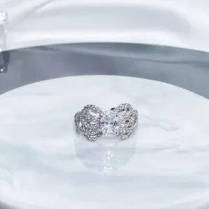 Detailed close-up of a silver bow-shaped open ring fully set with sparkling cubic zirconia