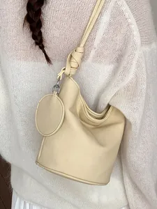 Elegant cream-colored large capacity leather bucket bag for stylish office commuting