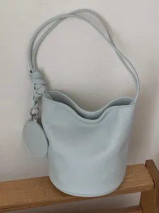 Minimalist light blue leather bucket bag for women, spacious commuter shoulder bag