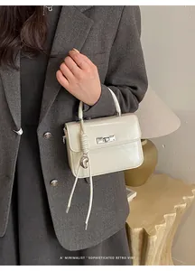 Chic cream white small square leather handbag with top handle and silver turn lock