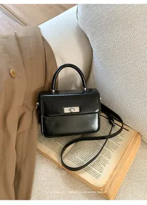 Black patent leather mini square handbag on retro book detail