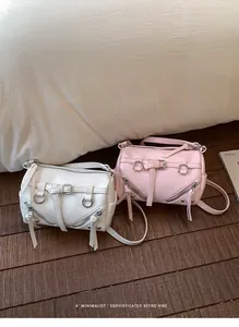 Chic minimalist white and pink retro shoulder bags on wooden floor