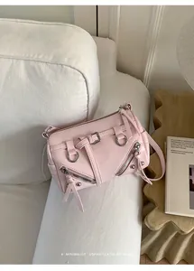 Chic pink pillow shoulder bag with trendy zipper and buckle details