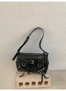 Close-up detail of the black retro shoulder pillow bag with silver hardware accents