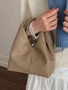 Taupe pebble grain leather pleated handbag with minimalist folded design for women