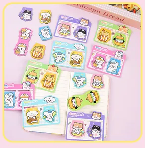 Detail of cute cartoon animal magnetic bookmarks featuring cats and dogs on a notebook