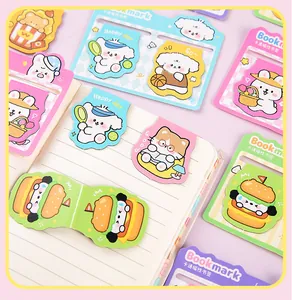 Assorted cute cartoon animal magnetic bookmarks displayed on a lined paper notebook