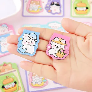 Cute cartoon animal shaped magnetic bookmarks held in hand for school stationery.