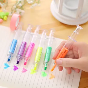 Creative syringe-shaped highlighter markers set used for drawing on lined paper