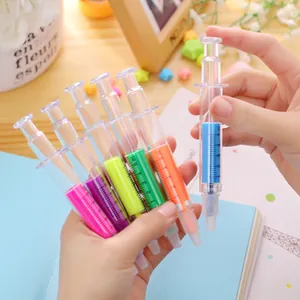 Close-up of cute syringe-shaped highlighters in multiple neon colors for stationery