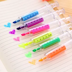 Creative syringe-shaped highlighters in six colors drawing neon hearts on paper