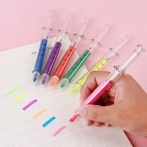 Creative set of 6 colorful syringe-shaped highlighters on a soft pink background