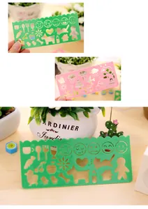 Detailed view of green plastic drawing stencil with emoji and animal patterns for students