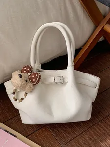 Elegante borsa tote bianca con fibbia decorativa e ciondolo a forma di orsetto