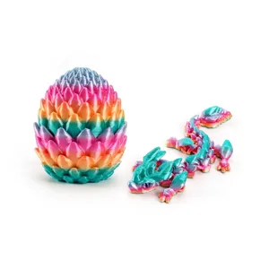 Detail of 3D printed silk candy gradient dragon egg and flexible articulated dragon