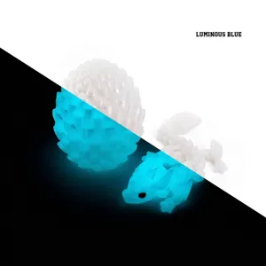 Split view of 3D printed luminous dragon egg showing day and glowing blue night effect