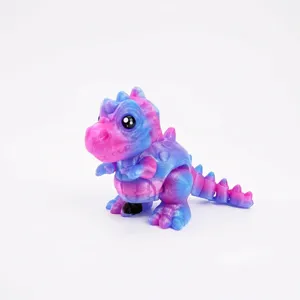 Close-up of a 3D-printed articulated T-Rex dinosaur toy with pink and blue gradient