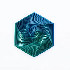 Top-down detail of a 3D printed fractal fidget hexagon in laser green-blue gradient.