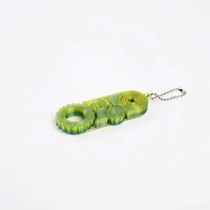 Detailed view of 3D printed 3-in-1 fidget toy with gear and slider in green yellow