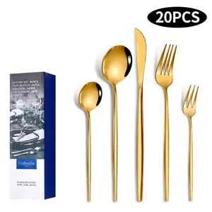 Detailed macro view of gold stainless steel cutlery set including knife and forks